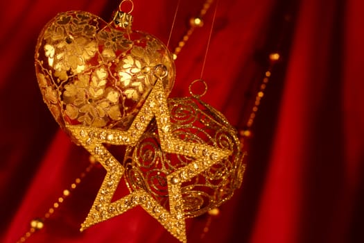 Golden christmas decoration on red fabric background