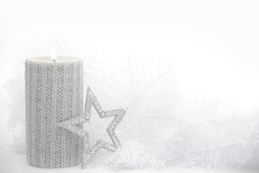 Christmas card with burning candle and decoration on white