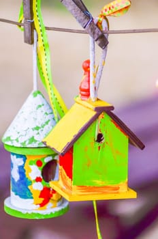 little colorful bird houses on clothes line