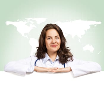 Young attractive female doctor put her hands on the blank banner, place for text