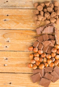 Chocolate candy and nuts displayed on an old wooden table