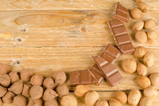 Nuts and chcolate displayed on a rustic wooden background