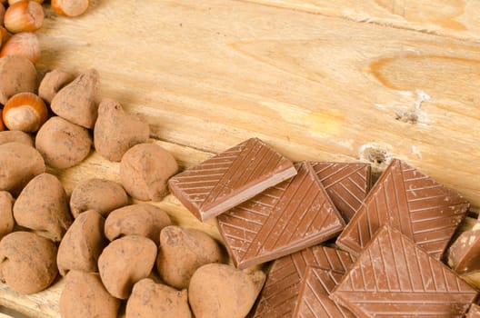 Chocolate treats with nuts displayed on a wooden table