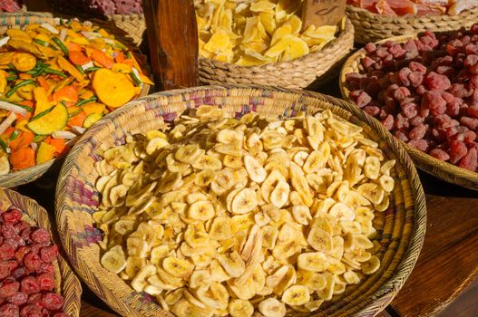 Assorted dried fruit displayed on a street market stall