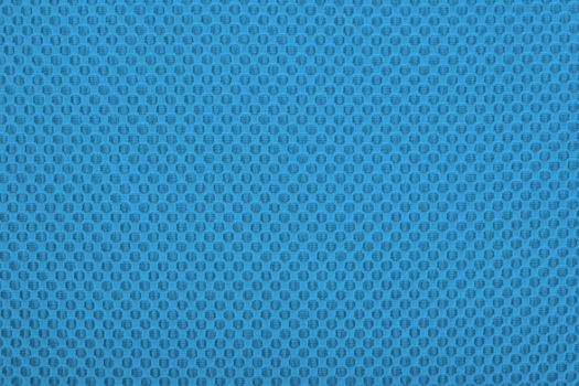 Blue fabric with dots, a textile background.