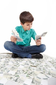 boy sitting on money, money concept, how to be successful, isolated on white background