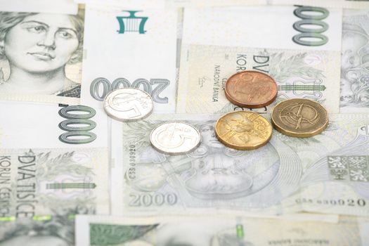 czech banknotes nominal value two thousand crowns and coins as background