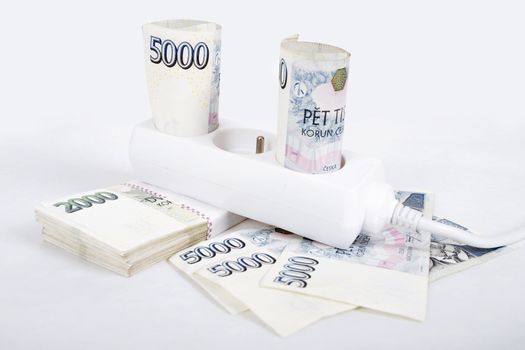 power cord and banknotes of czech crowns money concept of expensive energy bill