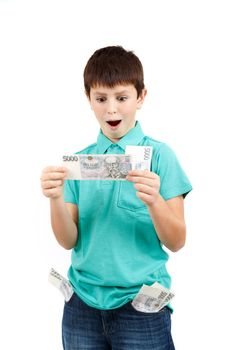 amazed boy looks at the bill from czech crown banknotes