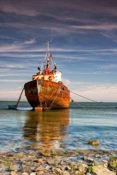 Old trawler on the beach in Rumpside