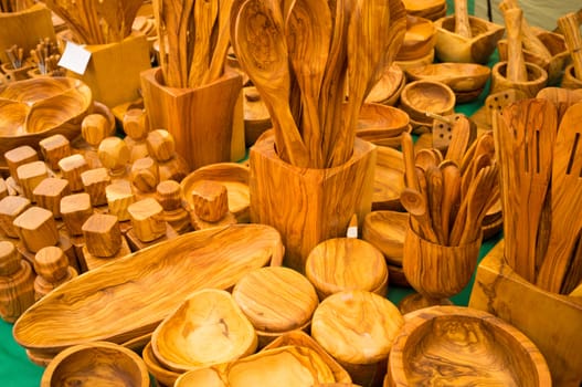 A vast assortment of handcrafted kitchen utensils as seen on a market stall