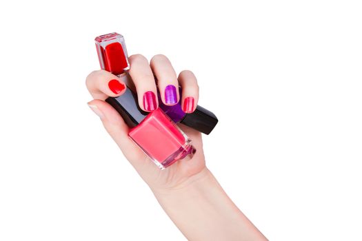 Young woman and bottles of colored nail polish