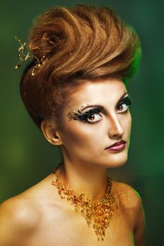 Close-up portrait of a young and attractive girl with hairstyle and jewelry