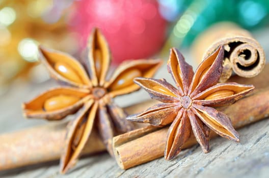 extremely closeup view of anise star and cinnamon sticks, on wooden table