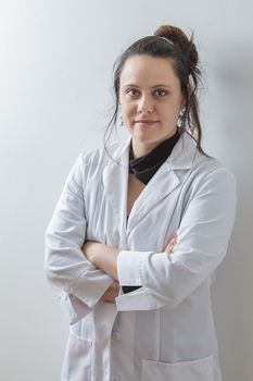 Woman in her thirtie wearing a white lab coat