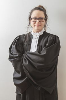 thirtie something brunette woman wearing a canadian lawyer toga with wispy hair