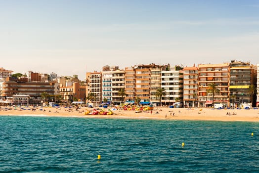 Lloret de Mar, Spain - October 13: Tourists enjoy beach in Lloret de Mar on Costa Brava shores on October 13, 2013