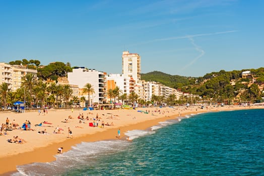 Lloret de Mar, Spain - October 13: Tourists enjoy beach in Lloret de Mar on Costa Brava shores on October 13, 2013