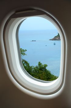 View sea and sky from window with airplane