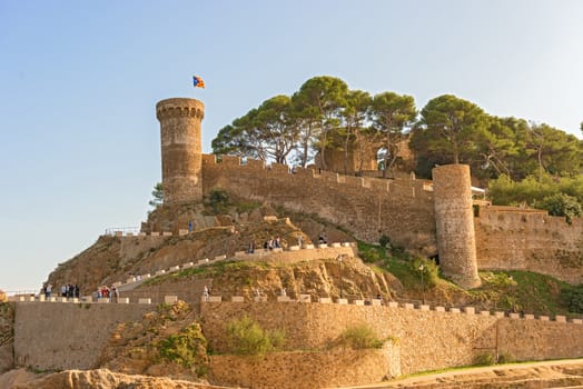 Tossa de Mar, Spain - October 13: Tourist entering medieval castle in Tossa de Mar, Catalonia, Spain, Costa Brava on October 13, 2013.