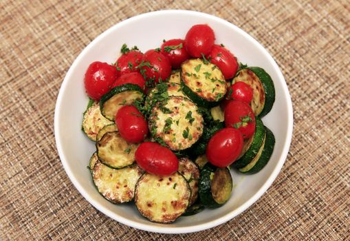 Fried zucchini and tomatoes with herbs
