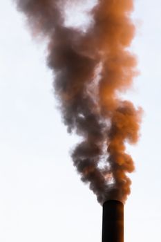 
Smokestack chimneys belching black smoke pollutants  into the atmosphere 
