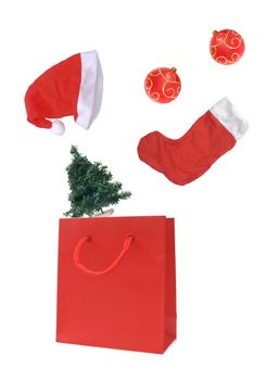 Christmas objects falling into a gift bag 