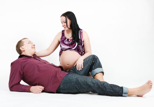 Young happy couple. Husband and pregnant wife. studio photography