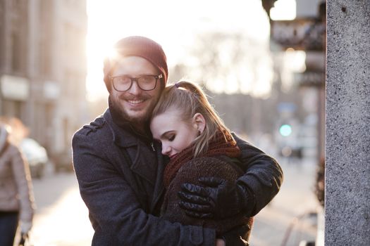 Young smiling happy european couple hugging in winter