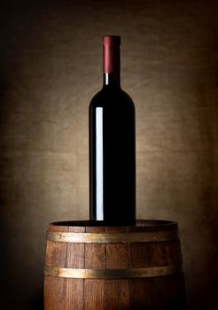 Bottle of wine on an old  barrel