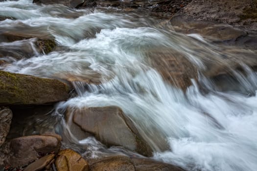 Fresh water in a mountain stream among stones
