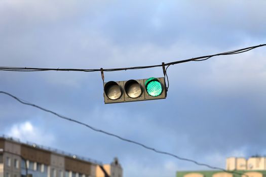 Traffic light on the background of the storm sky