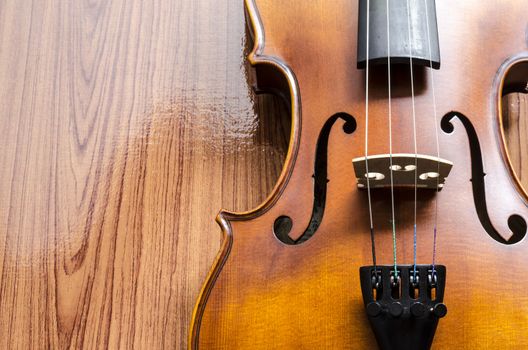 string instrument "violin" on wood background