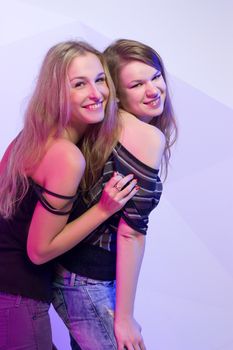 Portrait of two dancing girls on disco party