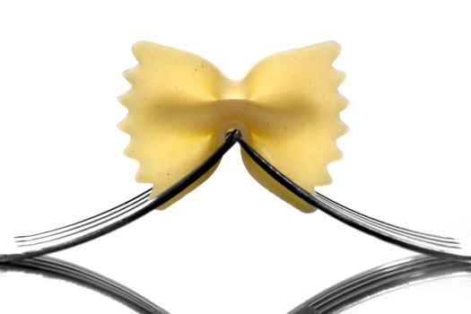 Farfalle pasta held by two forks.