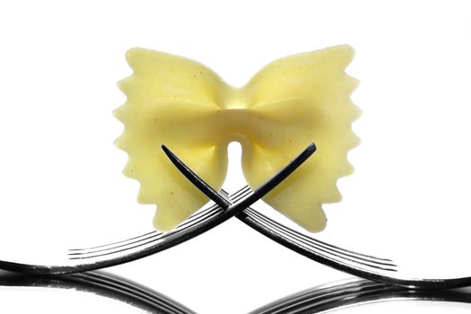 Farfalle pasta held by two forks.