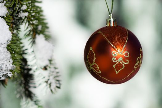 Christmas decoration hanging on tree with snow