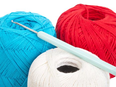 crochet needle and sewing thread in different colors