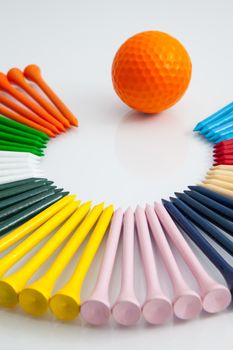 The different colorful wooden golf tees on the white background