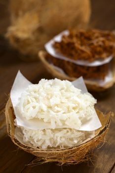 Peruvian cocadas, a traditional coconut dessert sold usually on the streets, made of grated coconut and white or brown sugar, which gives the different coloring of the sweet (Selective Focus, Focus on the front of the cocadas)