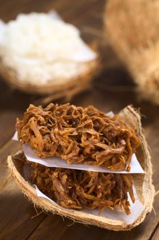 Peruvian cocadas, a traditional coconut dessert sold usually on the streets, made of grated coconut and white or brown sugar, which gives the different coloring of the sweet (Selective Focus, Focus on the front of the cocadas)