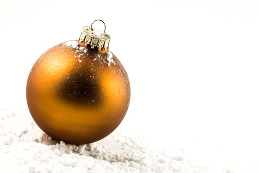 Christmas bronze ball on the snow