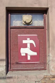 shop window with vintage shoe repair shop sign and ventilator