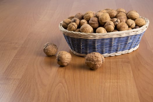 Nuts in a basket on a wooden background