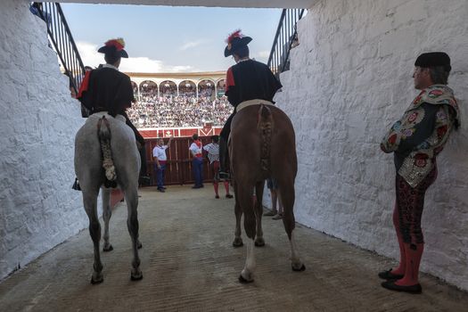 Pozoblanco, Cordoba province, SPAIN - 25 september 2011: Alguaciles on horseback iin the alleywaiting for the order to open the door from the Bullring to start the show, in Pozoblanco, Cordoba province, Andalusia, Spain