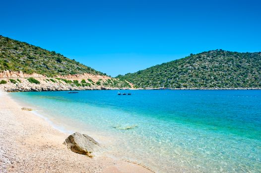 sea ​​cove surrounded by mountains with green vegetation