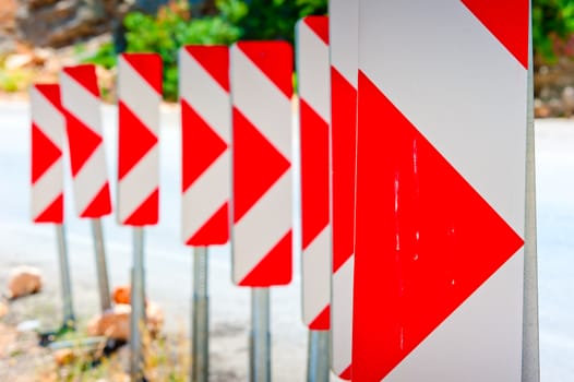 number of road signs warning of the dangerous turn