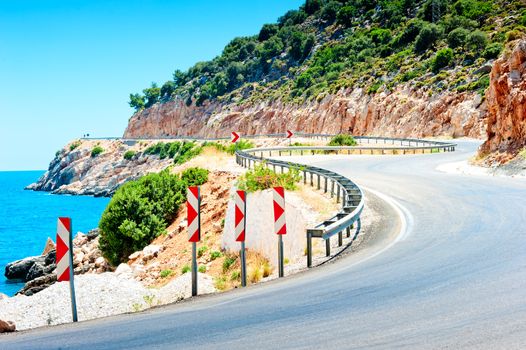 Road signs warn of the dangerous turn in the mountains