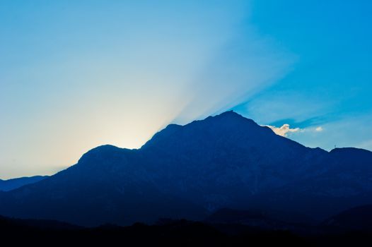 sun sets over the mountain Tahtalı, Turkey