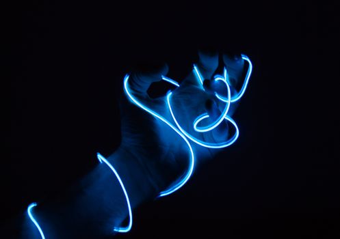 A hand is surrounded by electric curved lines.